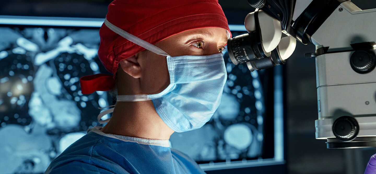 Doctor looking through a microscope