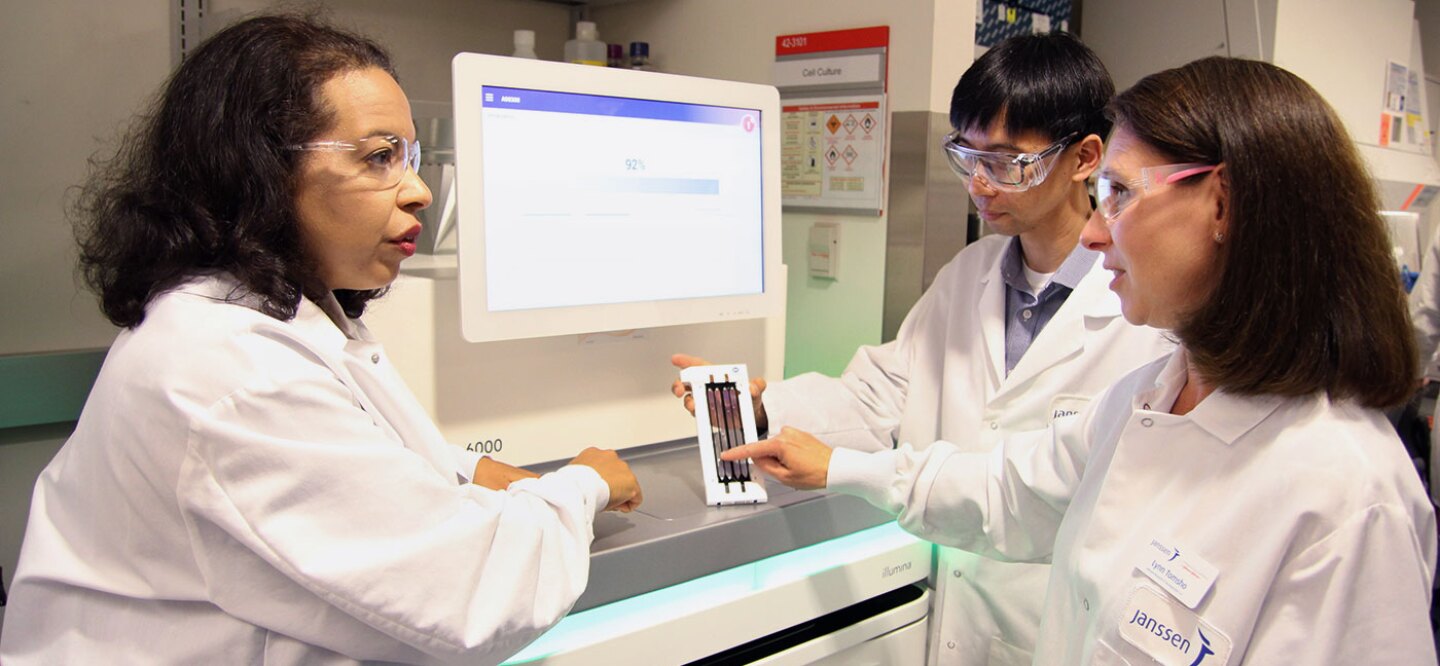 Esi Lamousé-Smith in the lab with colleagues reviewing microbial data
